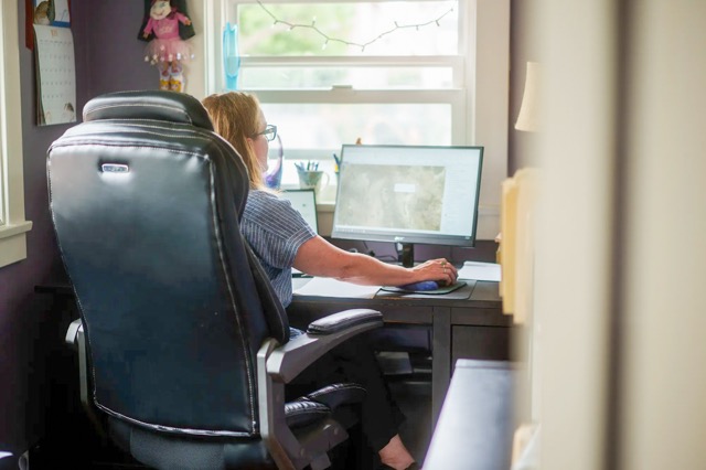 California Health Insurance. Heather Altman works at her desk, inside her home office in Long Beach on July 11, 2025.  Credit: Photo by Jules Hotz for CalMatters