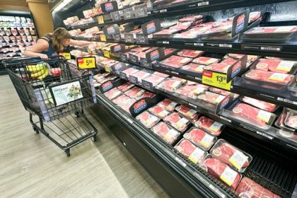 A shopper compares beef prices at a grocery store. Credit: AP Photo/Nam Y. Huh