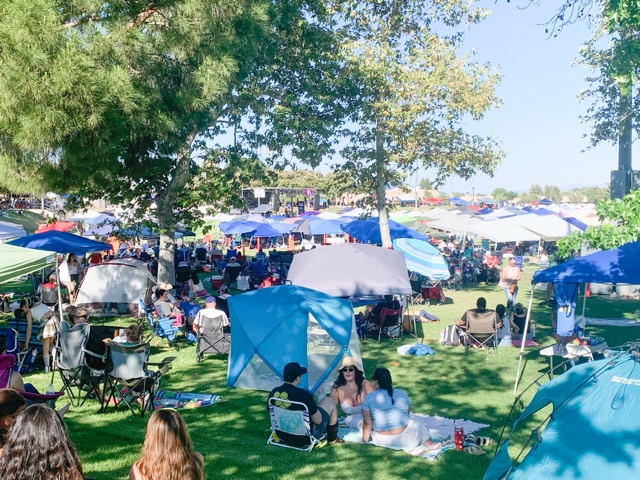 Guests packed themselves and their sunshades onto the  to California Oaks Sports Park fields to enjoy the opening band, the Duran Duran tribute show. Photo by Mia Rotell