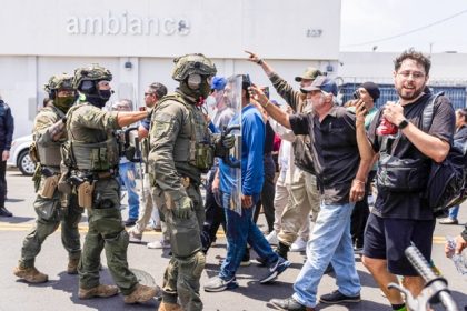 Federal immigration authorities face off against protesters during an ICE raid at Ambiance Apparel in Downtown Los Angeles on June 6, 2025. Photo by J.W. Hendricks for CalMatters