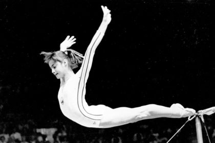 July 18. Romania's Nadia Comaneci dismounts from the uneven parallel bars to score a perfect 10.00 in the women's gymnastics competition at the 1976 Summer Olympic Games in Montreal. Credit: AP Photo/Suzanne Vlamis