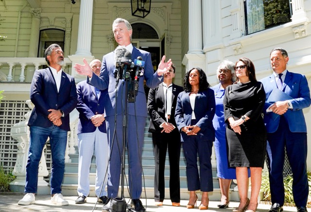 Redistricting. Gov. Gavin Newsom, accompanied by several members of the Texas state Legislature, calls for a new way for California to redraw its voting districts, during a news conference In Sacramento, last month.  Credit:  Photo by Rich Pedroncelli, AP