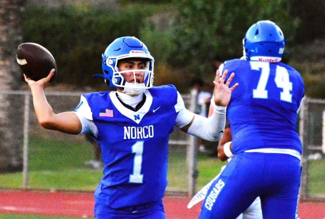 Norco’s Linebacker Henderson Carter made an incredible twisting interception of a Cajon pass, and raced 60 yards for a touchdown.  Intended receiver Landon White (1) pursues. 