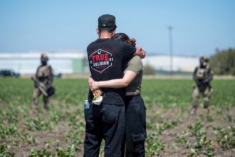 Immigration Raids. Arturo Rangel hugs Judith Ramos whose father works at the greenhouse in the background as federal immigration agents block access during a raid in the agriculture area of Camarillo, Calif., Thursday, July 10, 2025.