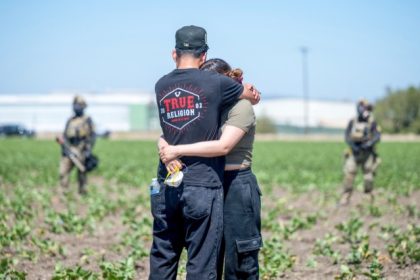 Immigration Raids. Arturo Rangel hugs Judith Ramos whose father works at the greenhouse in the background as federal immigration agents block access during a raid in the agriculture area of Camarillo, Calif., Thursday, July 10, 2025. Credit: AP Photo/Michael Owen Baker