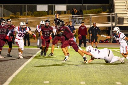 Paloma Valley QB Orlando Gonzalez (1) gets pantsed by Sonny Coward on his way to a touchdown.
