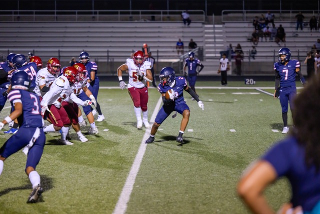 Demerius Norman (2) looking to extend his run, faces a wall of Indian Springs defenders.