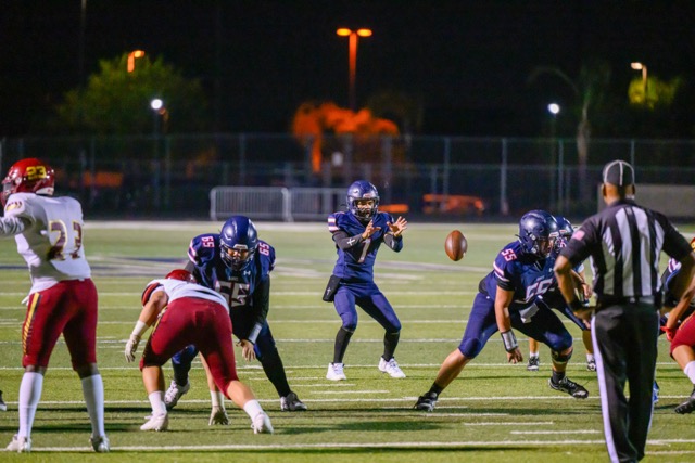 QB John Guitron (7) receives a snap from C Samuel Salcido (55).