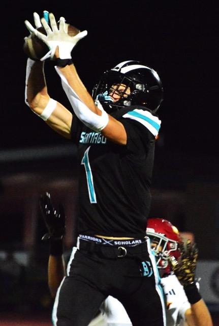 Santiago’s Ryan Wilson (1) snags a pass from quarterback Clayton Plewe in front of Hillcrest defender Dylan Bailey. 
