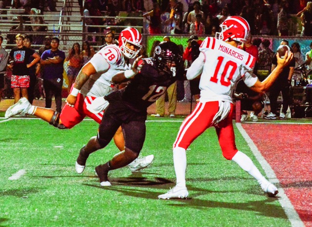Corona Centennial’s Jonathan McKinley II (12) is about to hit Mater Dei QB Ryan Hopkins (10) as he attempts to pass.  The pass fluttered into the hands of defensive back Jaden Walk-Green, who raced 10 yards for the pick 6, giving the Huskies and early 14 – 0 lead. 