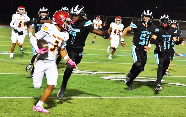Santiago’s Khailil Chancy (7) is zeroing in on Hillcrest’s Matthew Ramos (3) ending a long kickoff return as Hillcrest’s Hudson Nguyen (6) Jorge Torreblanca (56) and Chris Cortes (42), and Santiago’s Drake Zimolzak (0) Conner Trask (51) Axel Velazquez (11), and Chad McMaster (58) trail the play.  