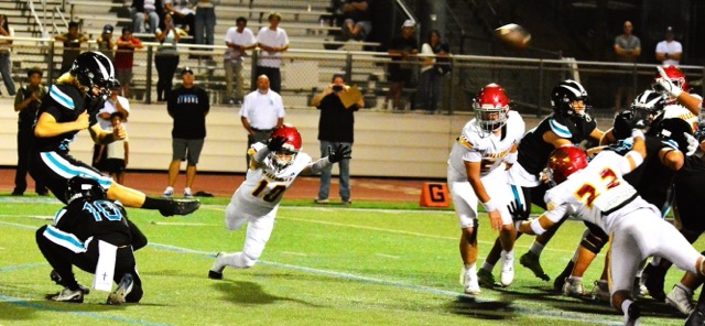Santiago kicker Carter Tiedt (left) off the hold of Jake Wilson (10) boots the game winning field goal over Hillcrest as time expired.  Trojan defenders Chase Ruehl (10), Camren Stuebner (50) and Angel Maldonado (22) attempt the block. In an instant classic, the Sharks and Trojans traded scores, leads, and big plays.  Santiago won 52 – 50. 
