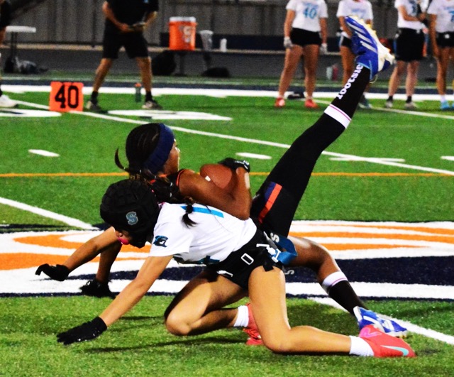 Eastvale Roosevelt’s Peyton Wade (top) makes an incredible leaping snag of a pass while Santiago’s Sophea Hernandez (bottom) tries to defend.  The Sharks defeated the Mustangs 24 – 12.