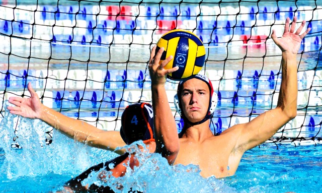 Roosevelt’s Dustin Silva (center) gets ready to blast a shot past Ramona goalie Andrew Rahner (1).