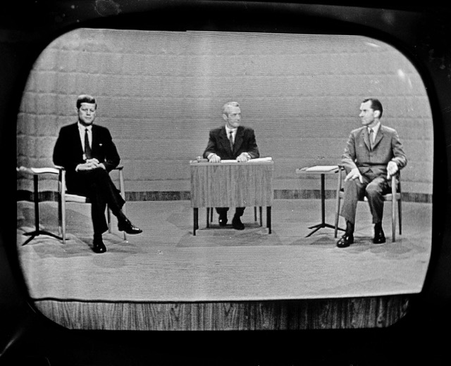 September 26 - Democrat Sen. John Kennedy, left and Republican Richard Nixon, right, as they debated campaign issues at a Chicago television studio on Sept. 26, 1960. Moderator Howard K. Smith is at desk in center. Credit: AP