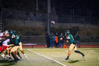 Tahquitz QB Travis Fiallos passes in the rain. The Rancho Verde Mustangs took down the Titans 26-0.