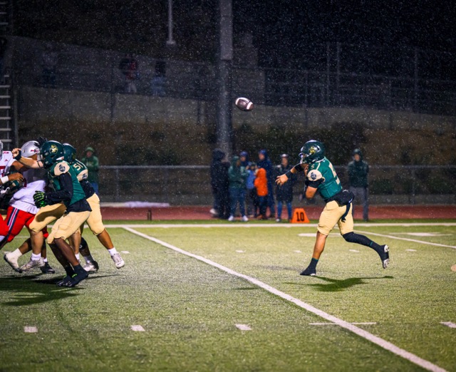 Tahquitz QB Travis Fiallos passes in the rain. The Rancho Verde Mustangs took down the Titans 26-0.