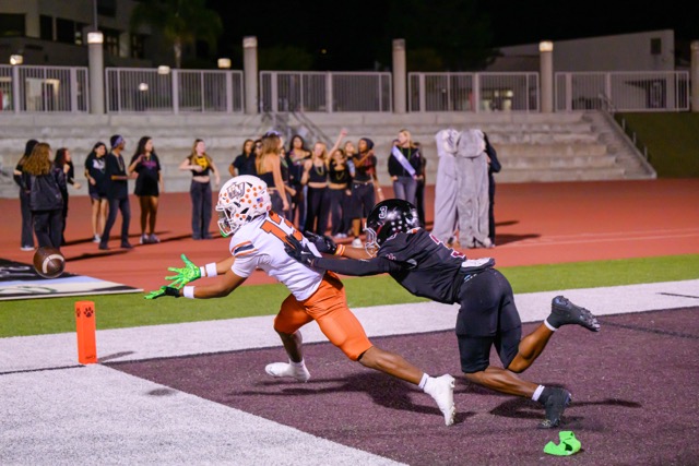 Coyote Zayshawn Washington (13) can’t make the catch that would have resulted in a TD. Wildcat Anthony Fayemiwo (3) breaks up the pass