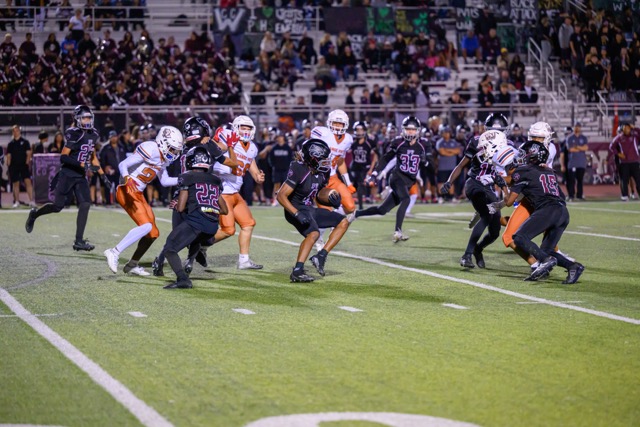 Wildcat Arthur Clemmons (4) shifts through defenders on a kick return.