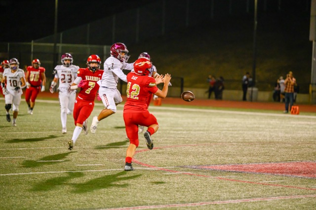 #7 Chris Vasquez climbs the ladder to rip the ball out of #42 Jaxson Day hands for the incompletion