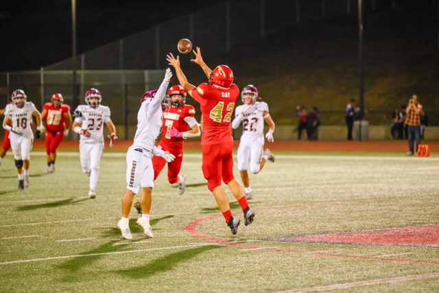 Longhorn CB #7 Chris Vasquez has his sights on breaking up a pass intended for Warriors WR #42 Jaxson Day