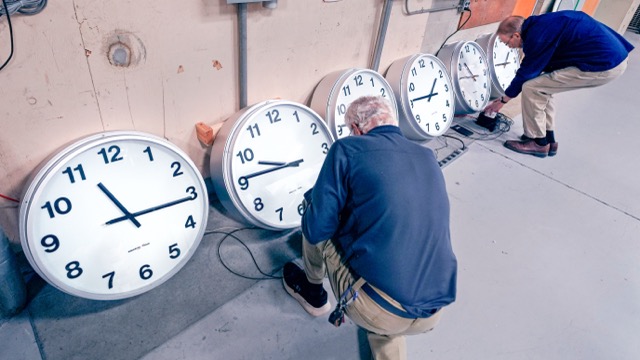 Fall Back. Clockmakers Rich Finn, left, and Tom Erb adjust the time zone controllers on a series of clocks that'll be installed at Paine Field in Everett, Wash., at the Electric Time Company, Wednesday, Oct. 30, 2024, in Medfield, Mass.  Credit: AP Photo/Charles Krupa
