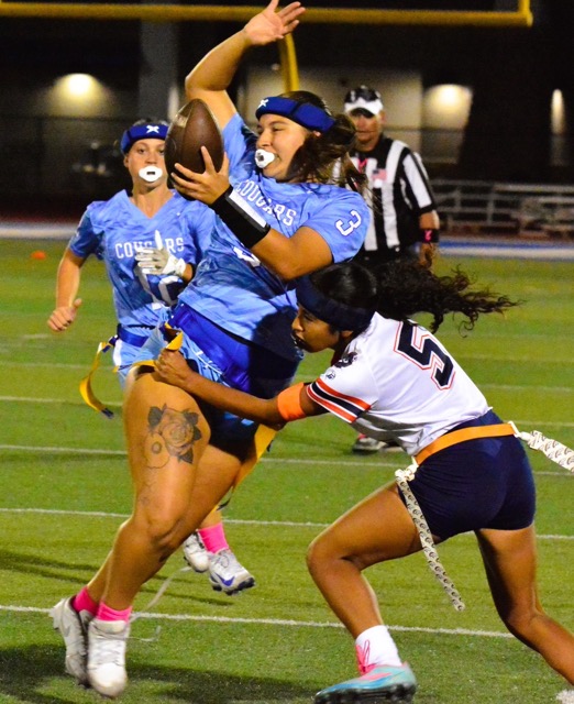 Norco High QB Mya Arriola (3) twists to avoid the flag pull of Eastvale Roosevelt’s Arianny Carretero (5).