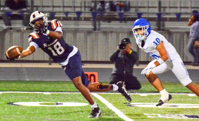 Eastvale Roosevelt’s Yankee Guitierrez (18) makes an incredible catch in front of Norco’s Manuel Hernandez (10) late in the game.  The Cougars defeated the Mustangs 50 – 14.