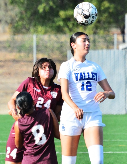 Norco’s Sierra Gutierrez (8) and Esmie Bustamante (24) watch San Bernardino Valley’s Jayla Orozco (12) execute a header.