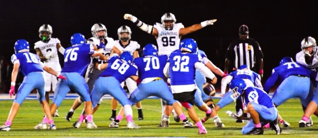 Temecula Chaparral’s Mahkai Caldwell (95) jumps up and yells at Norco kicker Mauricio Aguilar (32) during a field goal attempt to end the first half.  Norco’s Tegan Ogas (18), Michael Kasinger (76), Noah Kasinger (68), Logan Orozco (70), Joshua Cobian (29), and Kameron Cyiark (71) block while Konnor Calderon (13) is on the hold.  Aguilar was wide right on the attempt.  The Pumas defeated the Cougars 56 – 28.