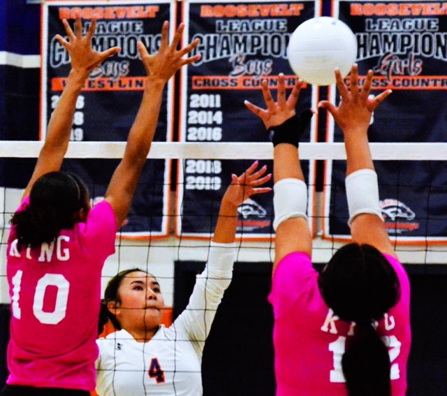 Eastvale Roosevelt’s Mya Capistrano (4) gets a dink over Riverside King’s Brooklyn Brackenridge (10) and Ariana Chavez (12).