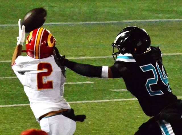 Corona receiver Benjamin Campusano (2) has a step on Santiago defender Khalil Page (24), but the ball slipped through his fingertips during this second-quarter play. The Sharks defeated the Panthers 37 – 21. Credit: Photo by Gary Evans