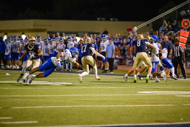 Vista Murrietaʻs Zachary Aleman runs through an attempted arm tackle by flying Norco sophomore linebacker Henderson Carter V on a kickoff return.