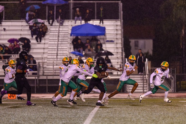 Perris (4) Darrick Cavitt-Hart breaks off an explosive run for over 20 yards before being tackled by a hoard of Coachella Valley players.