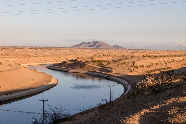 Colorado River Talks. The All American Canal flows past the Imperial Sand Dunes near Felicity on Dec. 5, 2022.  Credit: Photo by Caitlin Ochs, Reuters