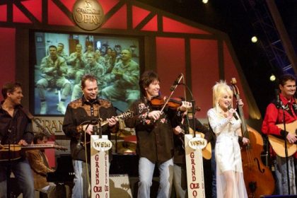 November 28. Country star Dolly Parton sings on stage during a Grand Ole Opry live broadcast in Nashville, Tenn., April 23 as U.S. soldiers watch the show via a video feed in Iraq. Credit US Department of Defense