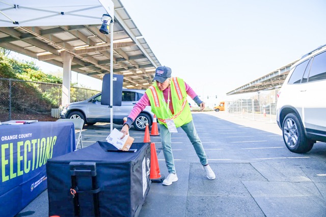 An election worker puts two ballots in a curbside ballot drop box outside a vote center at the Huntington Beach Central Library in Huntington Beach on Nov. 4, 2025. 

Credit: Photo by Jules Hotz for CalMatters
