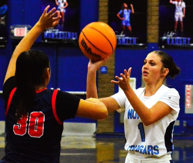 La Sierra’s Lailee Jaramillo (30) tries to block the shot by Norco’s Aaliyah Taylor (1) during the Cougars’ come-from-behind 34 – 26 win over the Eagles Wednesday night.
