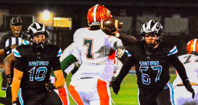 Corona Santiago’s Jake Wilson (10) and Caleb Joh (67) rush Riverside Poly Quarterback Marjok Gustafson (7) during the first round CIF playoff game. The Bears defeated the Sharks 34 to 24 and advanced to play San Dimas.