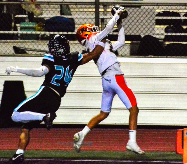 Corona Santiago’s Khalil Page (24) can’t stop Riverside Poly receiver Kevin Paul Williams (right) from making a fantastic first half touchdown reception. to play San Dimas.