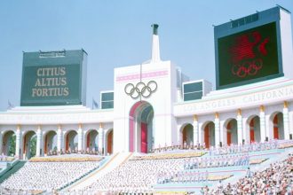 LA28. Olympic Torch Tower of the Los Angeles Coliseum on the day of the opening ceremonies of the 1984 Summer Olympics. The Coliseum will co-host the opening ceremony and be home to the closing ceremony in 2028. It is the only venue to have hosted in 3 separate Olympics- 1932, 1984, and 2028.