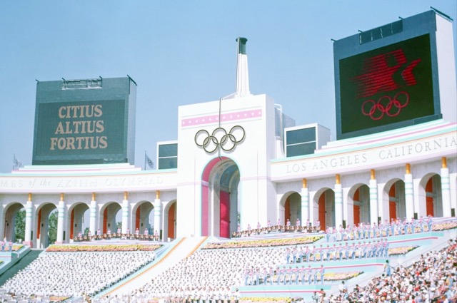 LA28. Olympic Torch Tower of the Los Angeles Coliseum on the day of the opening ceremonies of the 1984 Summer Olympics. The Coliseum will co-host the opening ceremony and be home to the closing ceremony in 2028. It is the only venue to have hosted in 3 separate Olympics- 1932, 1984, and 2028.