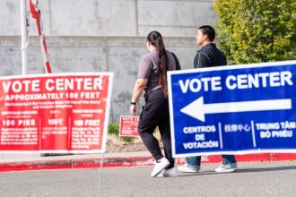 People walk by the vote center at Valley Ni-North Laguna Library in Sacramento on Nov. 4, 2025.  Credit: Photo by Jungho Kim for CalMatters