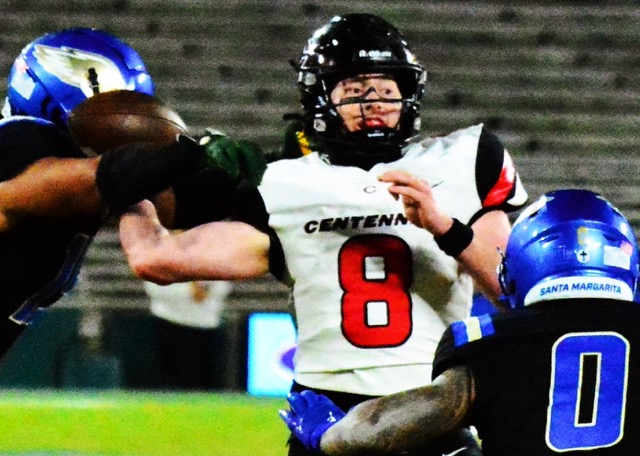 Santa Margarita’s Vai Manutai (left) hits Corona Centennial QB Dominick Catalano (8) while he attempts to pass during the second quarter of the CIF Division 1 Championship game played at the historic Rose Bowl in Pasadena.  The pass fell incomplete as Dash Fifita (0) rushes Catalano.  The Eagles captured the Open Division crown 42 – 7. Both of the Huskies’ losses this year were inflicted by Santa Margarita; the regular-season contest went to overtime.