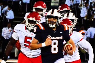 Eastvale Roosevelt QB Matthew Ochoa (8) is chased by a host of Pius X/St.Matthias defenders in the CIF Division 6 semi-final game.