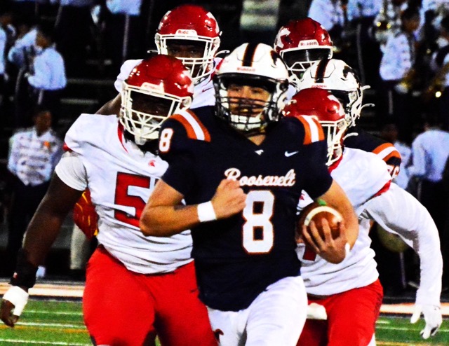 Eastvale Roosevelt QB Matthew Ochoa (8) is chased by a host of Pius X/St.Matthias defenders in the CIF Division 6 semi-final game.