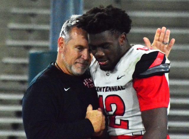 Corona Centennial Head Football Coach Matt Logan consoles senior linebacker and Cal Berkley commit, Jonathan McKinely II.