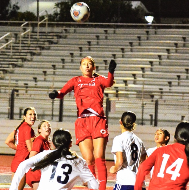 Featured Photos 12-12-2025. Corona’s Giselle Fuentes-Gonzalez (center) rises above the pitch for a header on goal in last week’s game against Redlands. The Panthers defeated the Terriers 1 – 0.