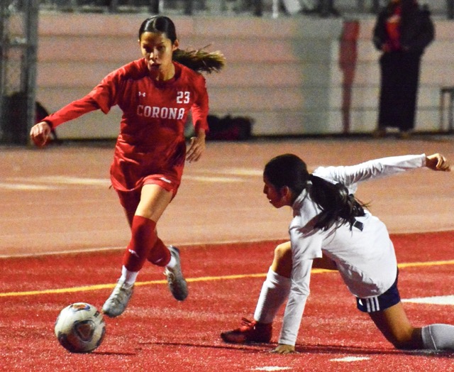 Corona’s Alondra Guerrero (23) gets past a Redlands player.