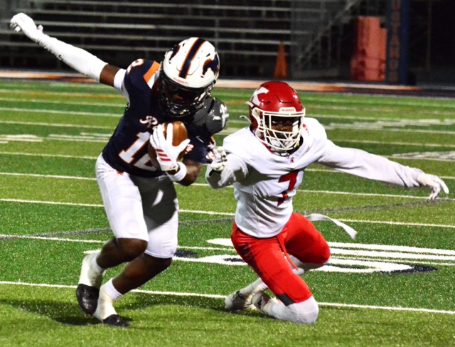 Eastvale Roosevelt receiver Darion Rubin (12) makes a catch and move on Piux X/St Matthias defender Edward Spriggs (7)
